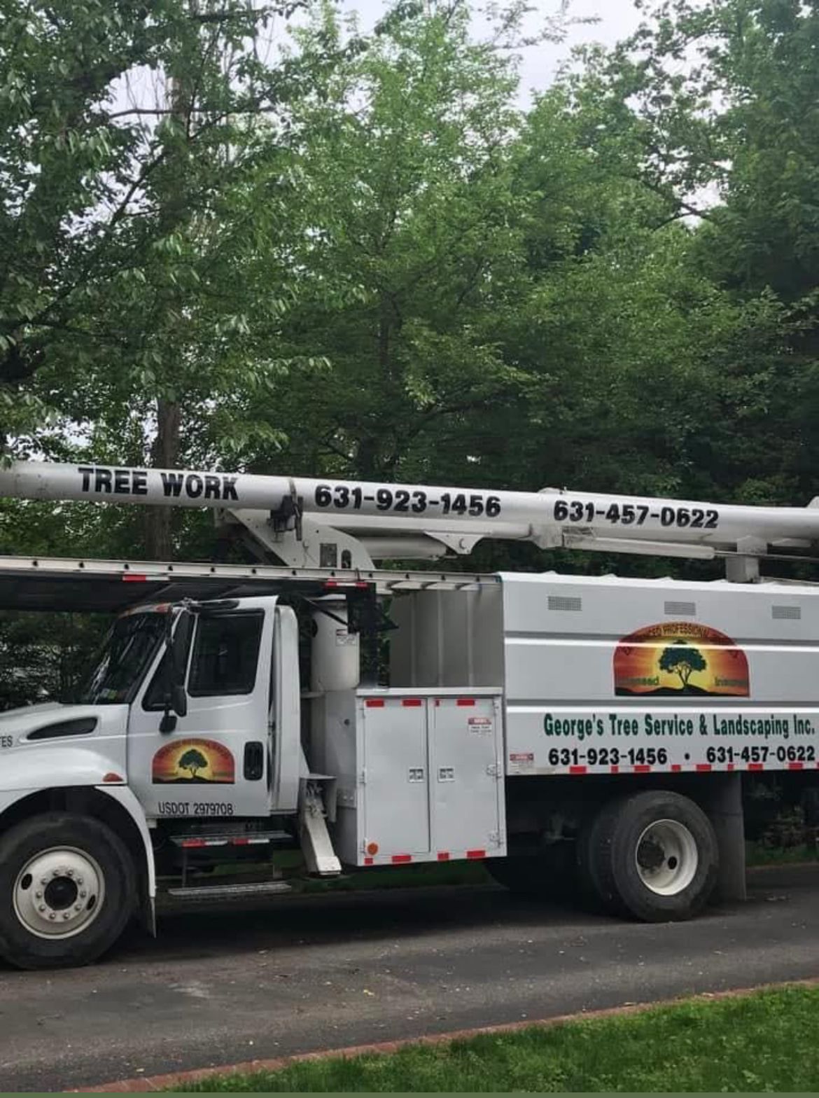 A tree work truck is parked on the side of the road