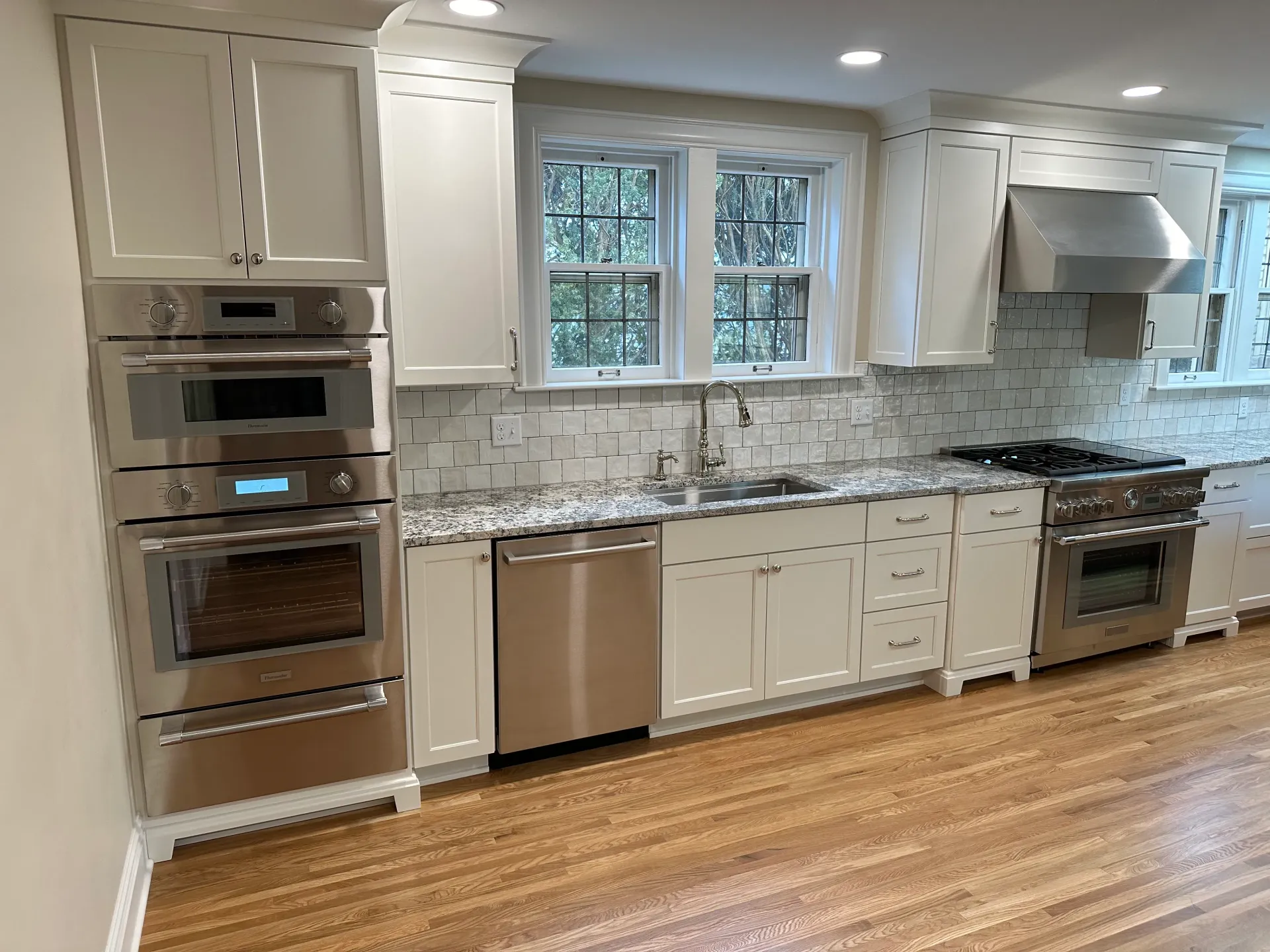 Kitchen with white cabinets, stainless steel appliances, and a granite countertop.