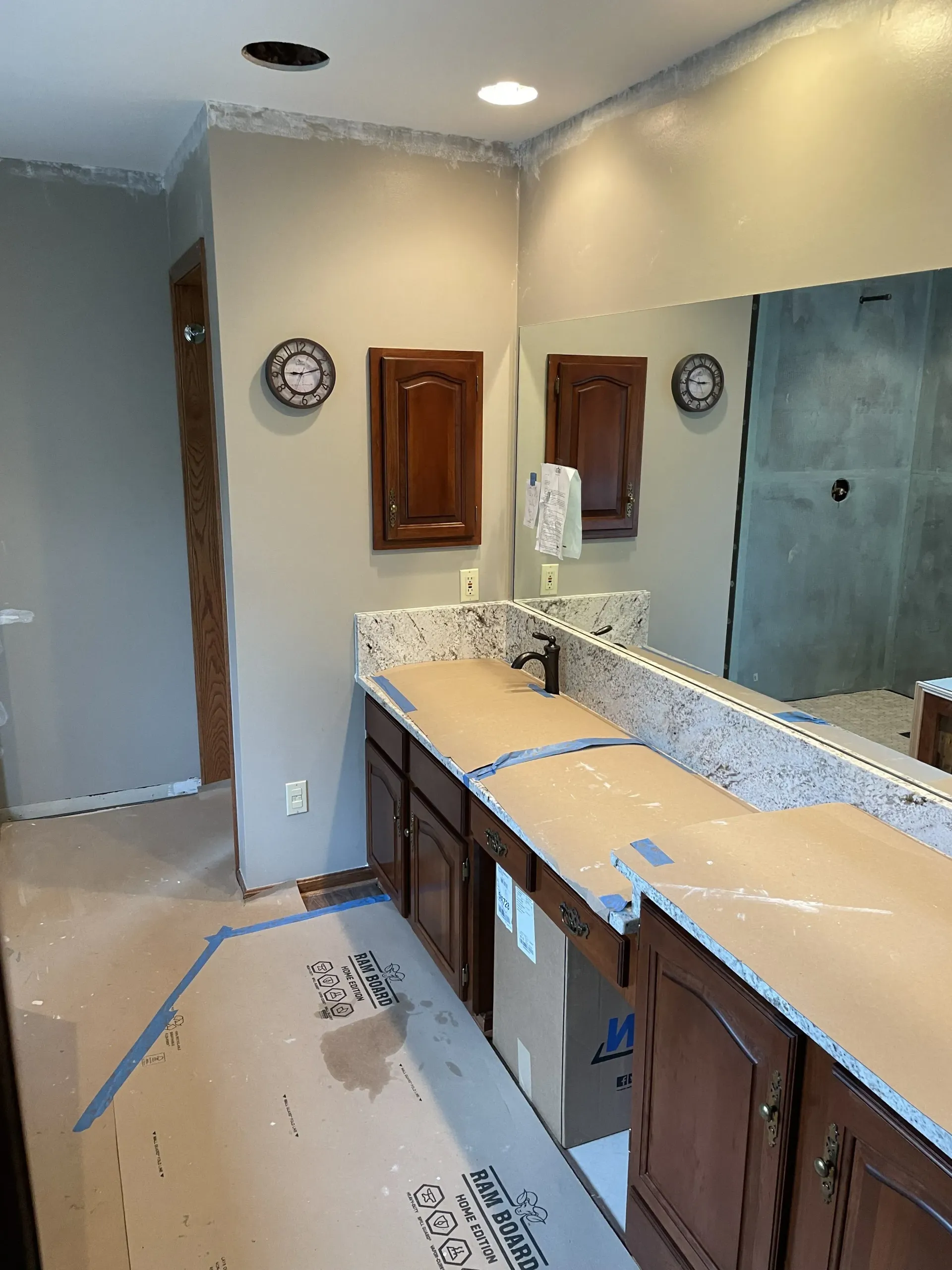 Bathroom remodel in progress with new vanity and cabinets.