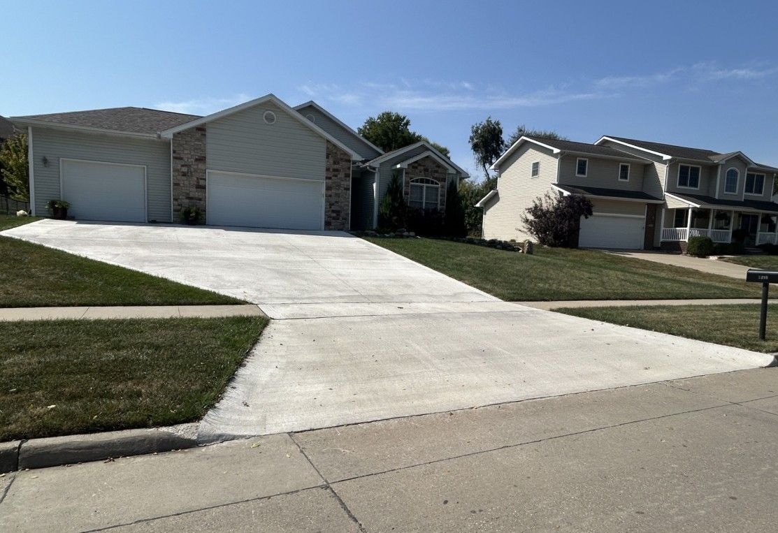 Concrete driveways leading to houses on a sunny day.