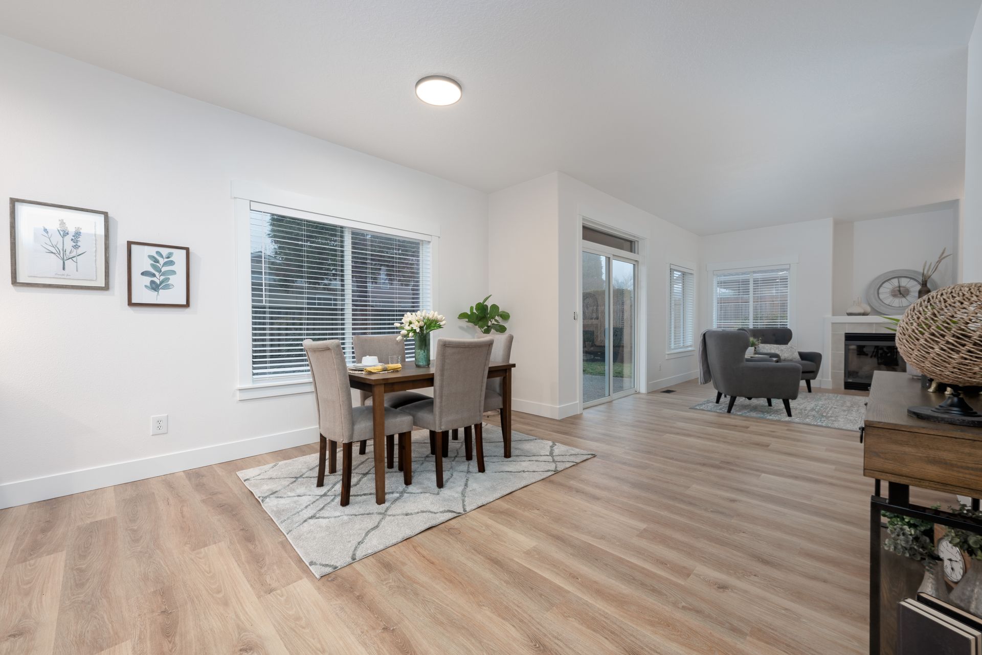 Dining area with table, chairs, and open to living space with sliding glass door to yard.