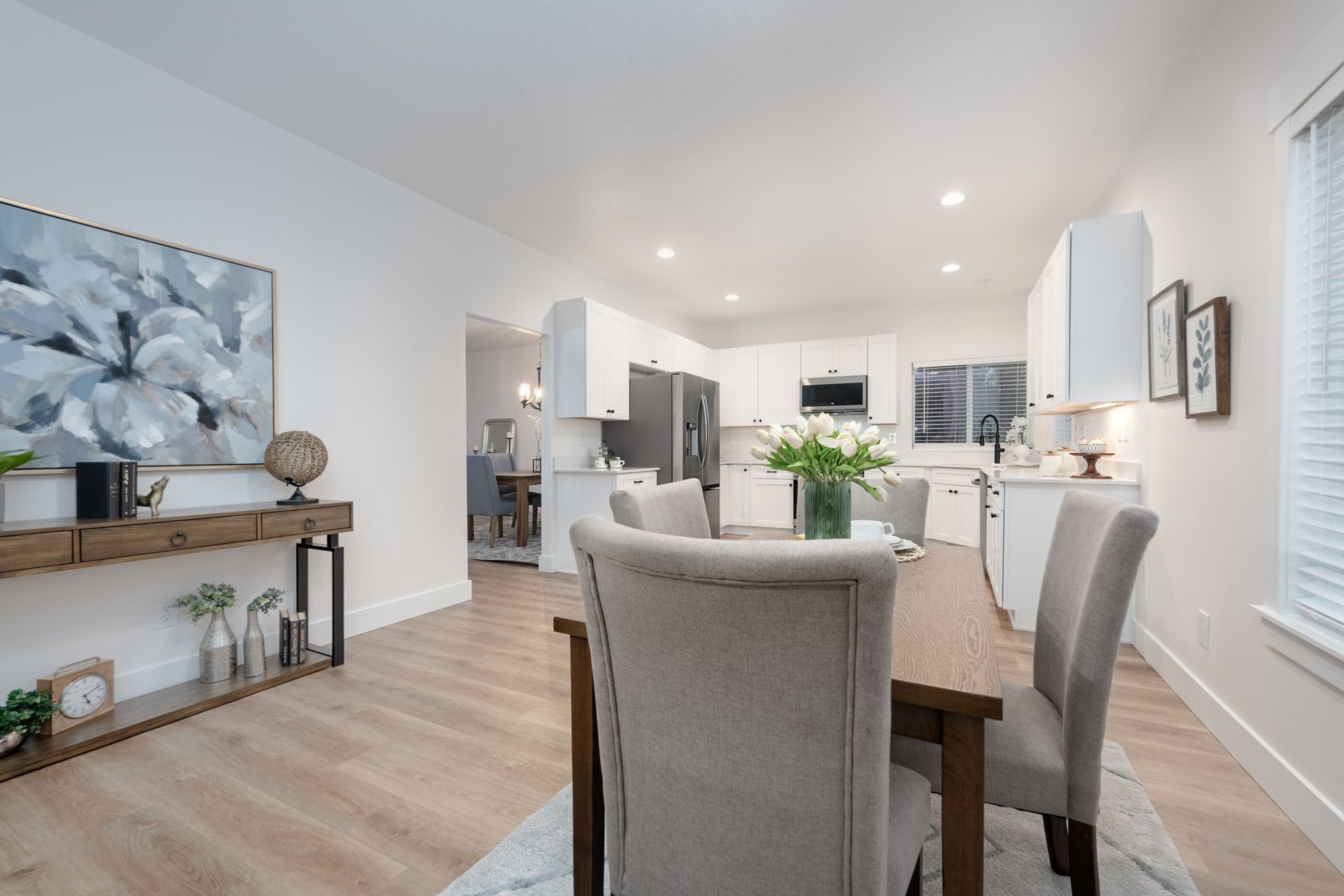 Dining room with table and chairs, leading to kitchen and living area.