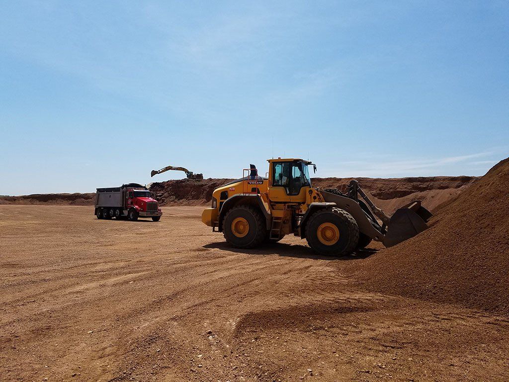 Scooping up road materials.