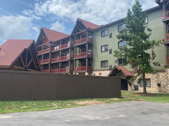 A large apartment building with a fence in front of it