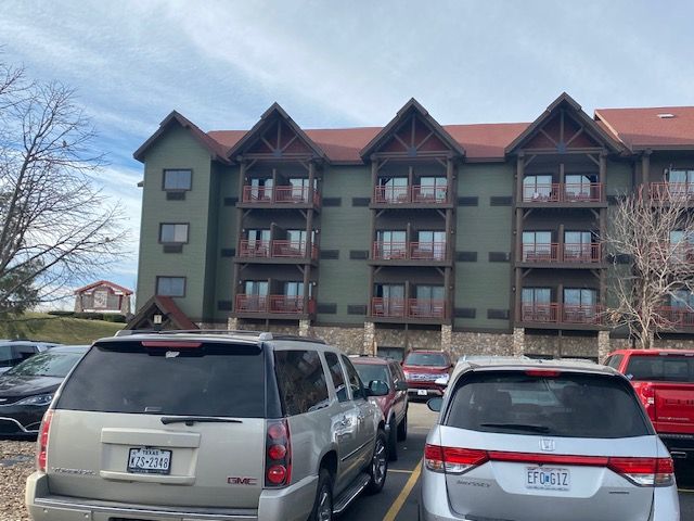 A building with a lot of cars parked in front of it
