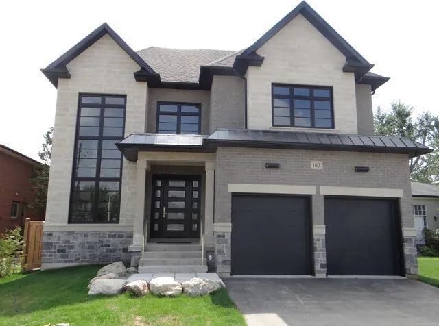 The front of a house with two garage doors