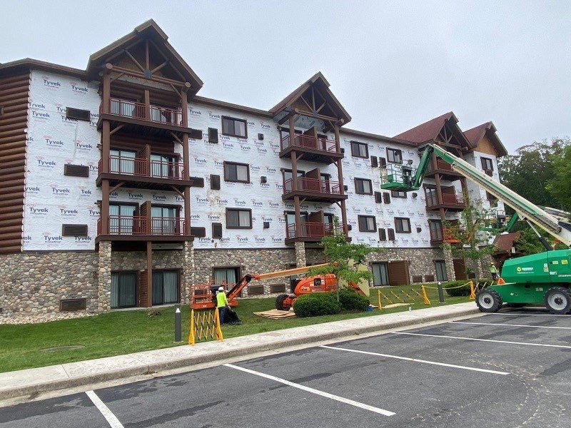 A large building with a lot of windows and balconies is being built.