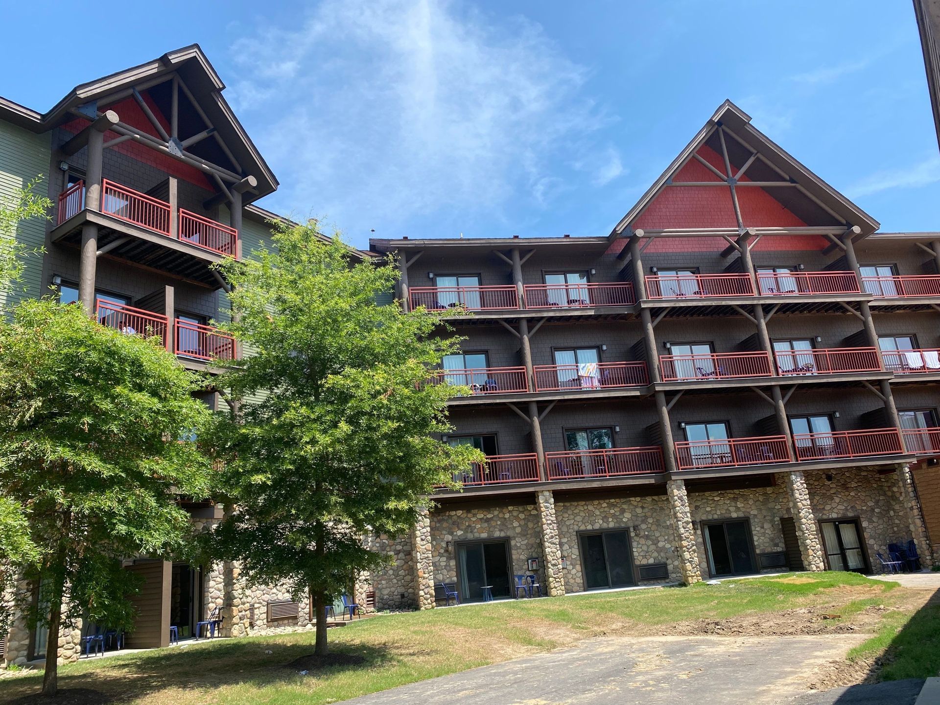A large building with a lot of balconies and trees in front of it.