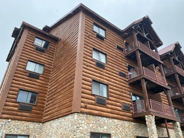 A large wooden building with a lot of windows and balconies.