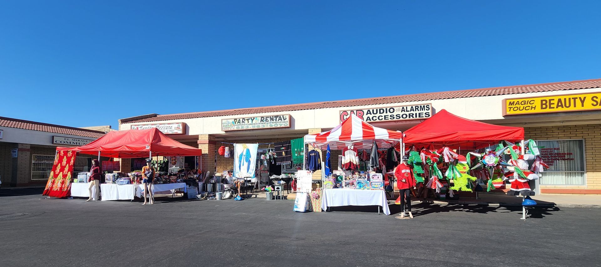 a store front with a lot of red tents in front of it