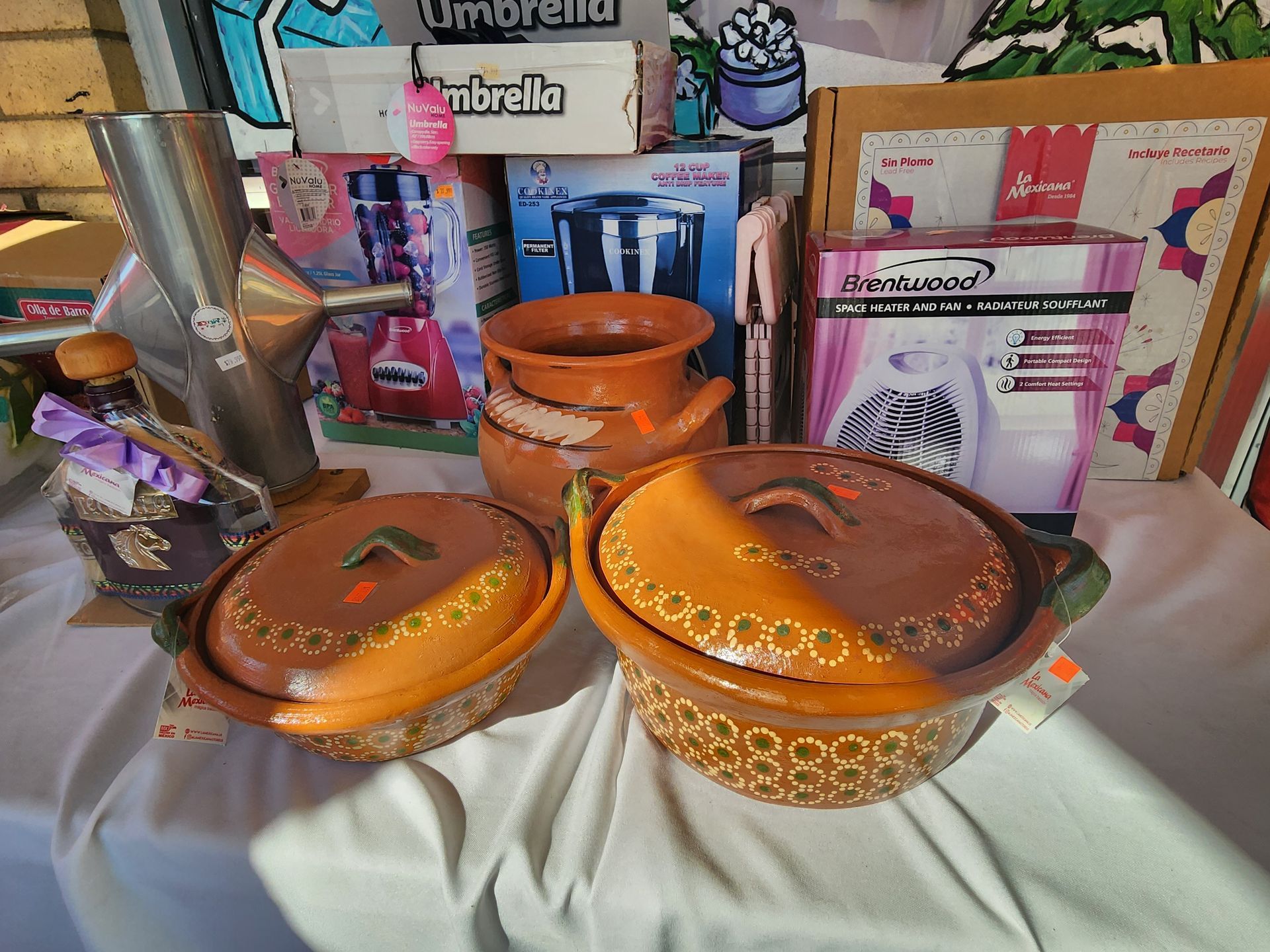 a table with a bunch of pots and pans on it