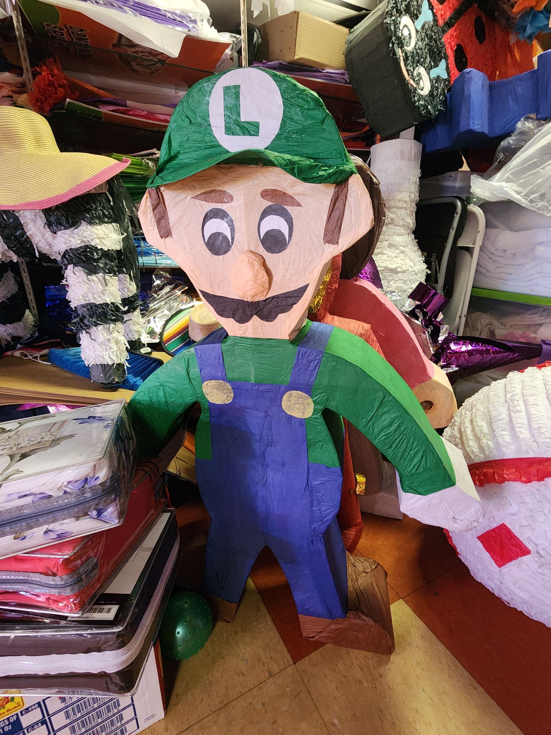 a piñata of luigi from mario bros is sitting on a table .