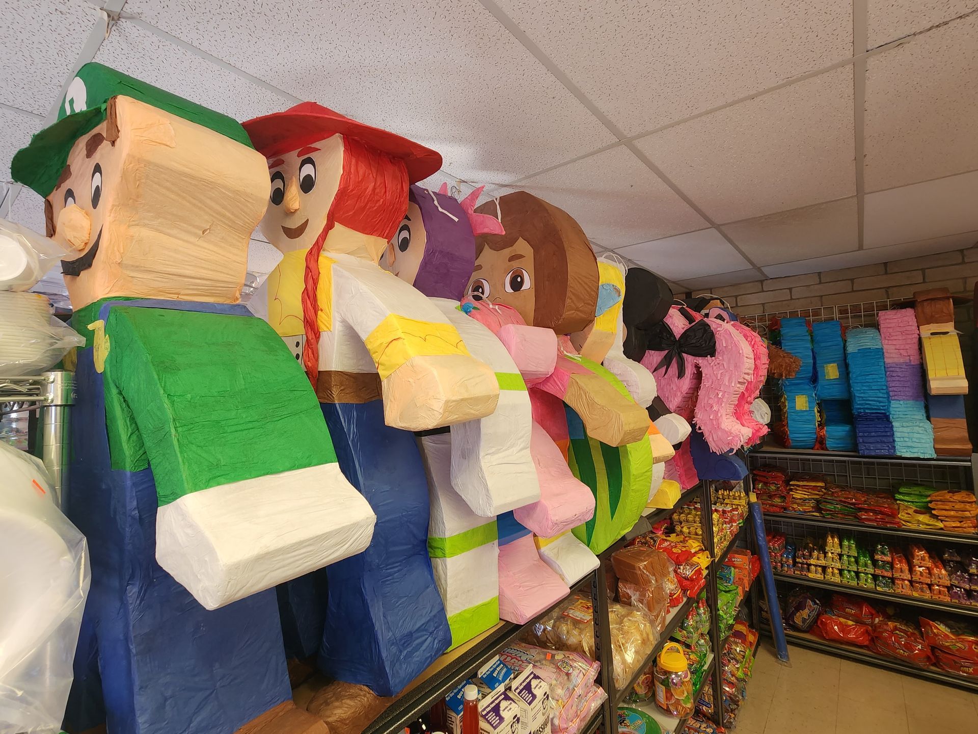 a bunch of pinatas are lined up on a shelf in a store