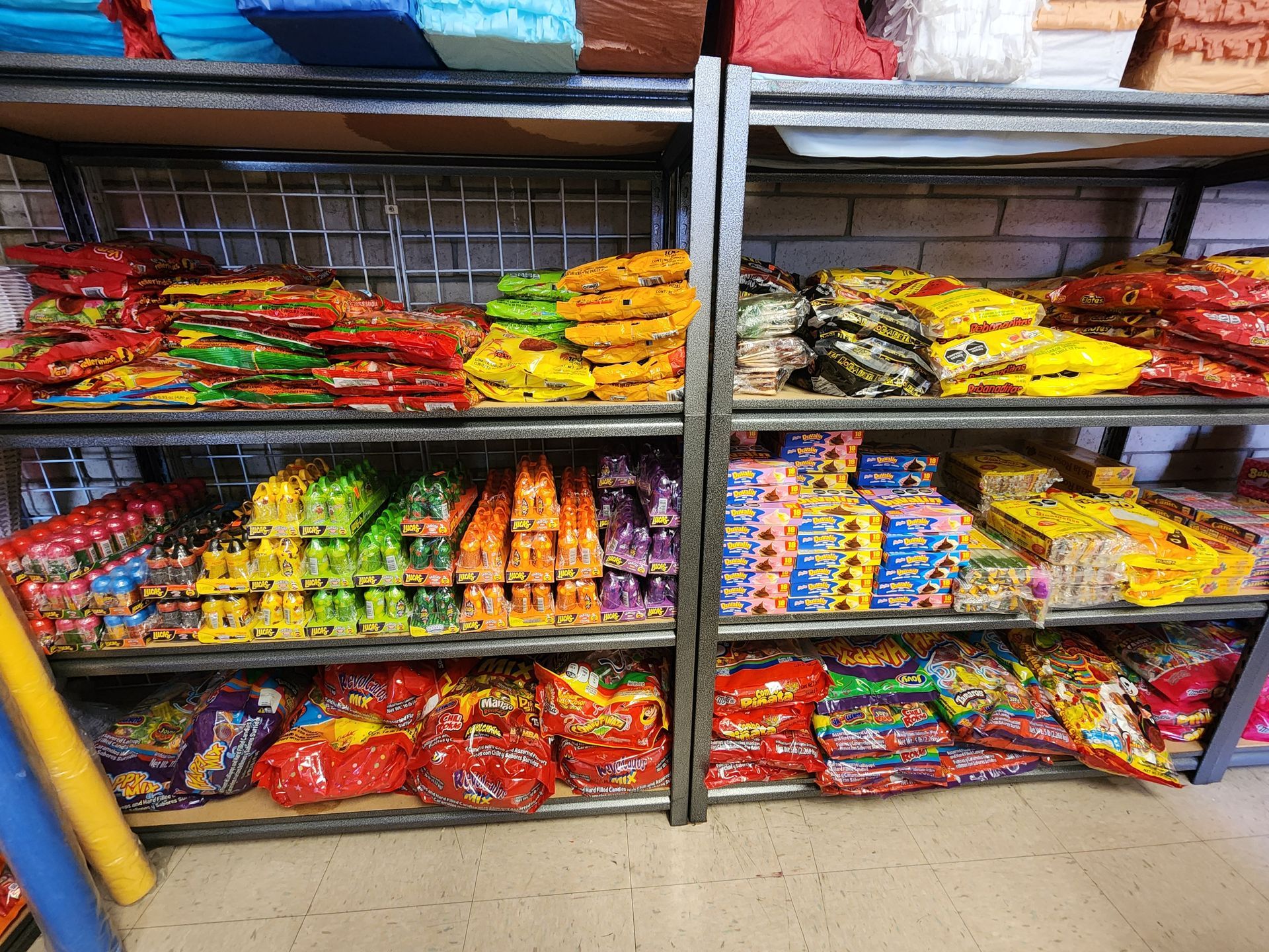 a store shelf filled with lots of different types of candy .