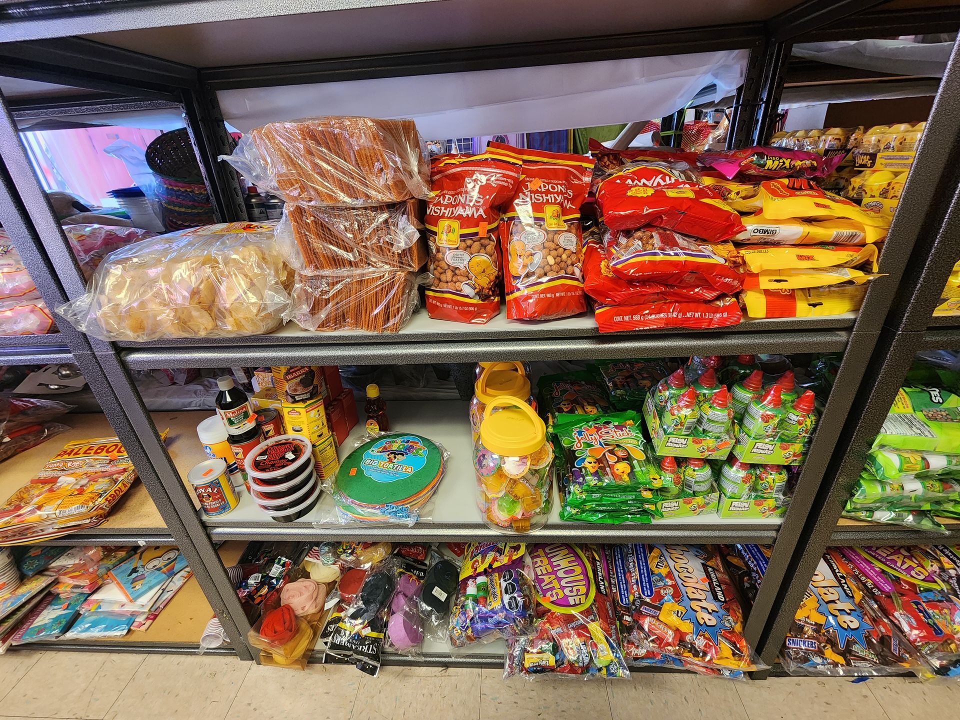 a store shelf filled with lots of candy and snacks .