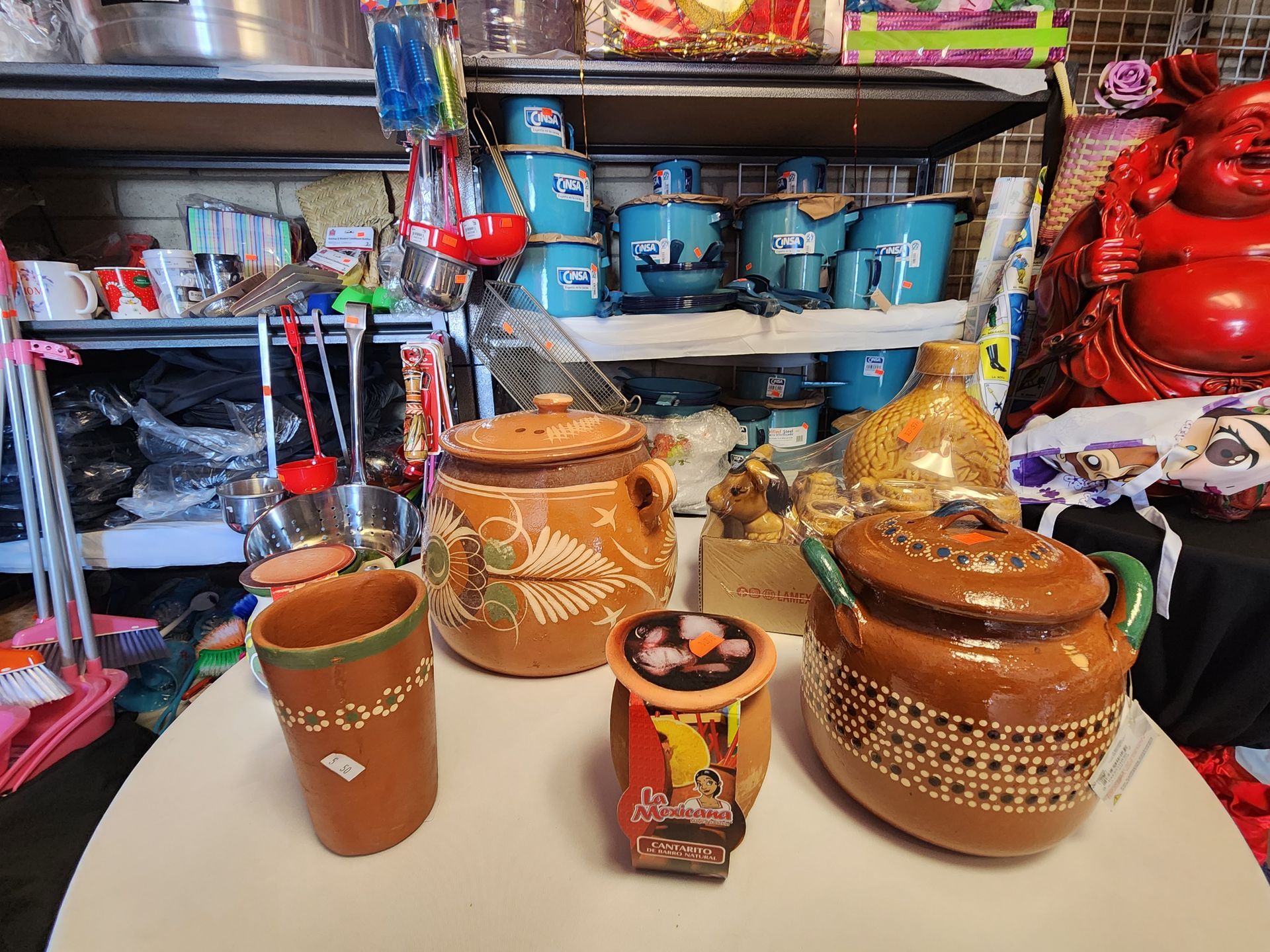 a table with a lot of pots and cups on it .
