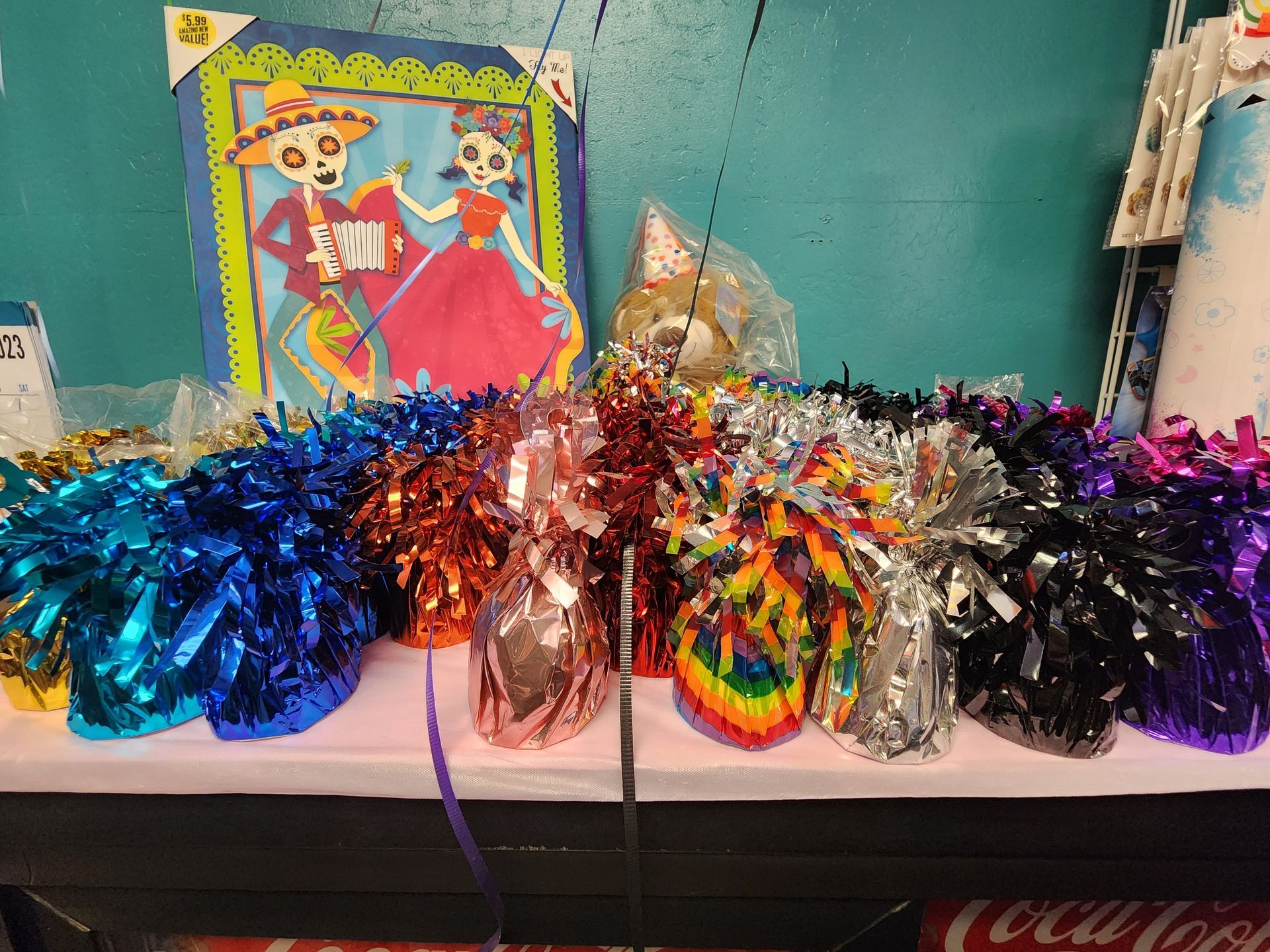 a table with a bunch of colorful balloon weights on it