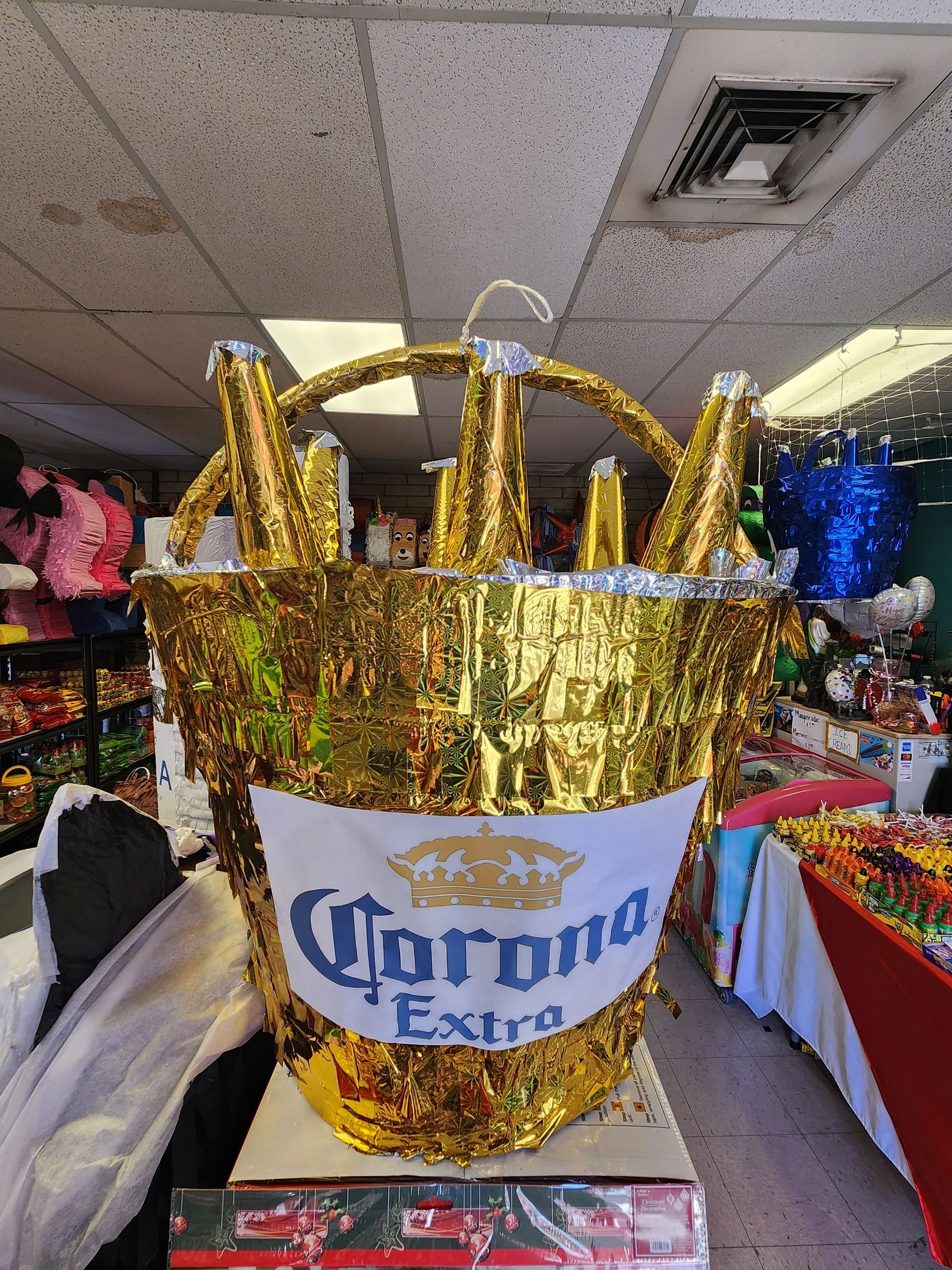 a gold bucket pinata with corona extra written on it