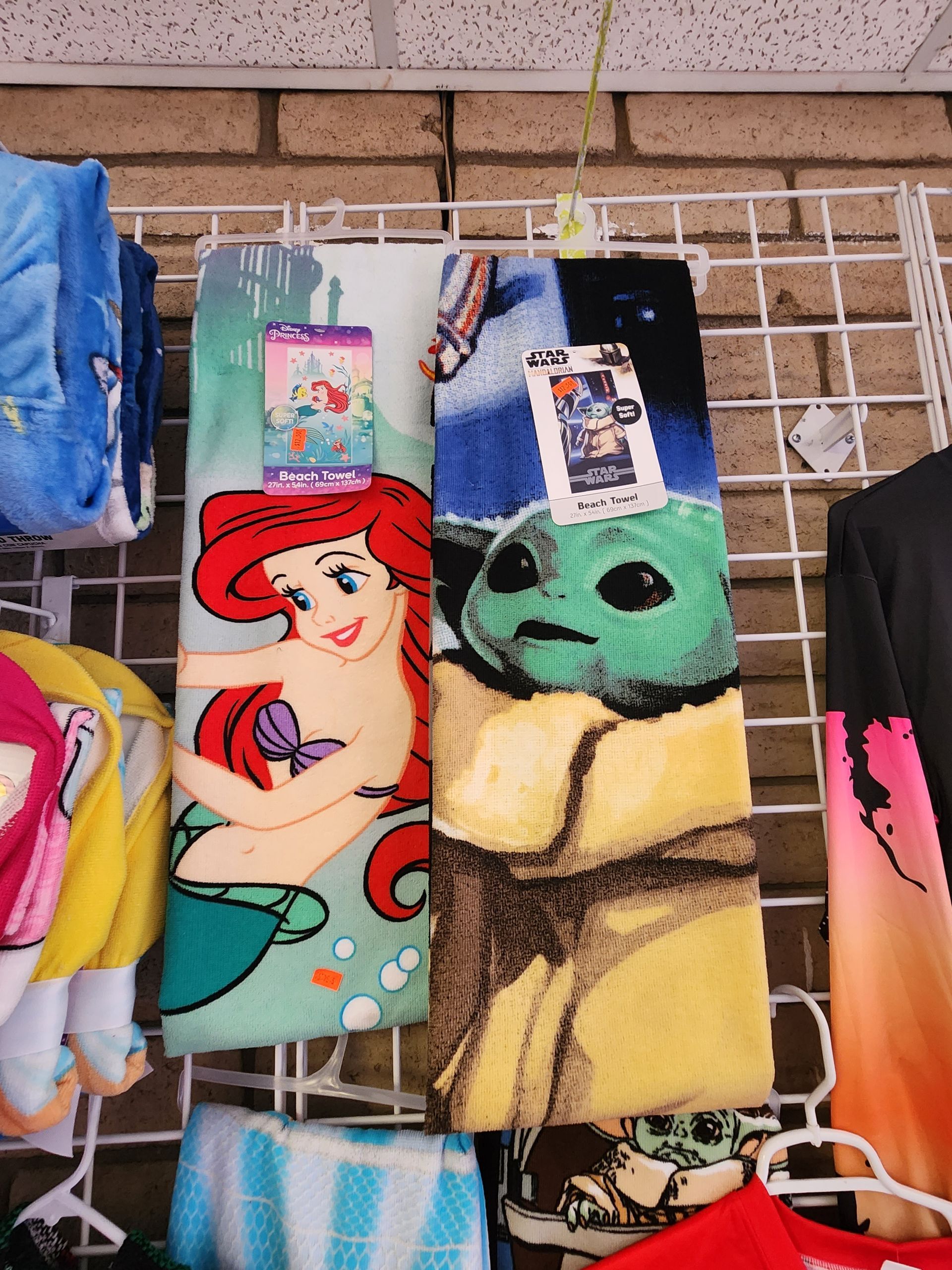 ariel and the baby yoda towels are hanging on a rack