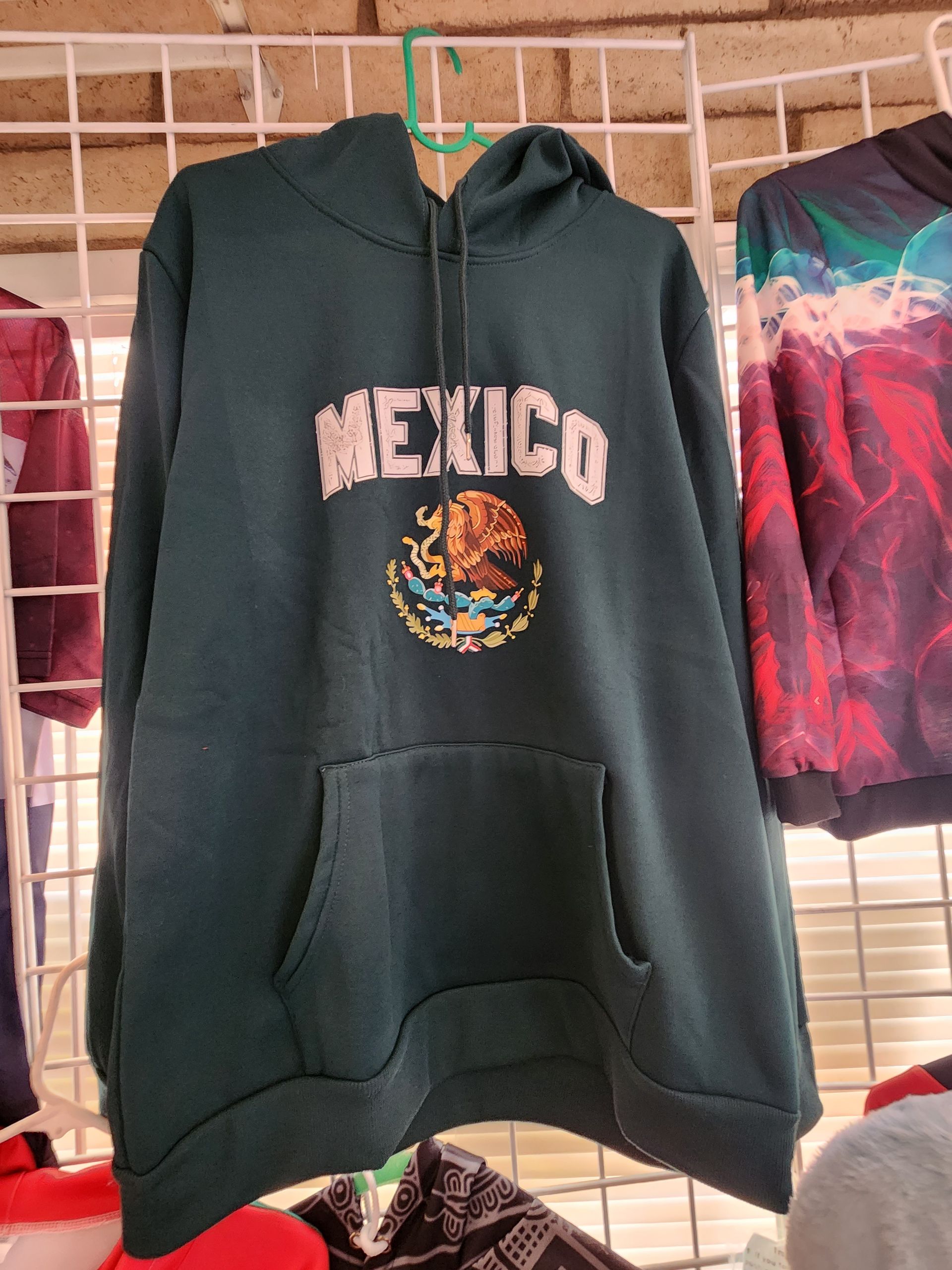 a green hoodie with the word mexico on it