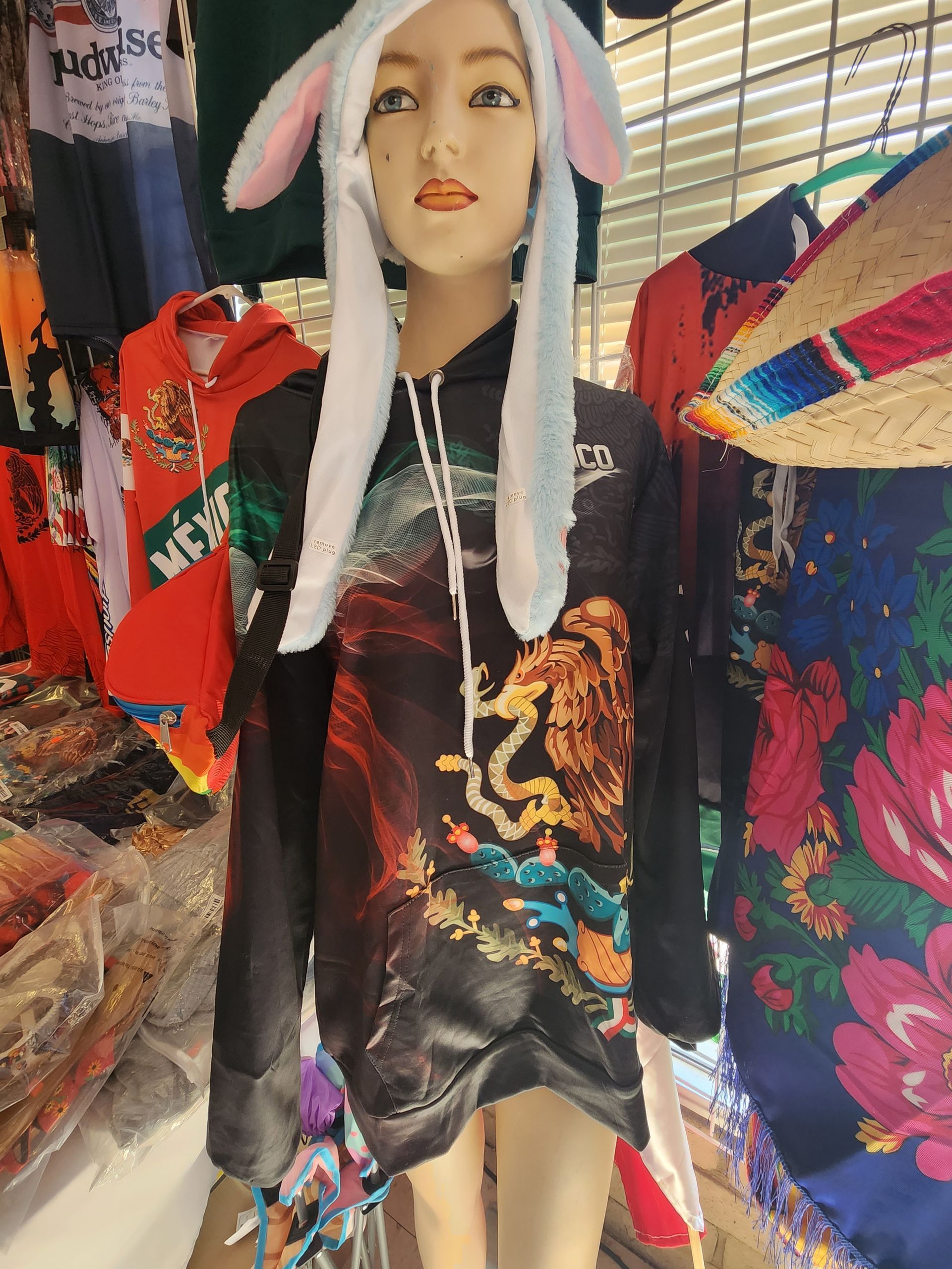 a mannequin wearing a bunny hat and a hoodie .