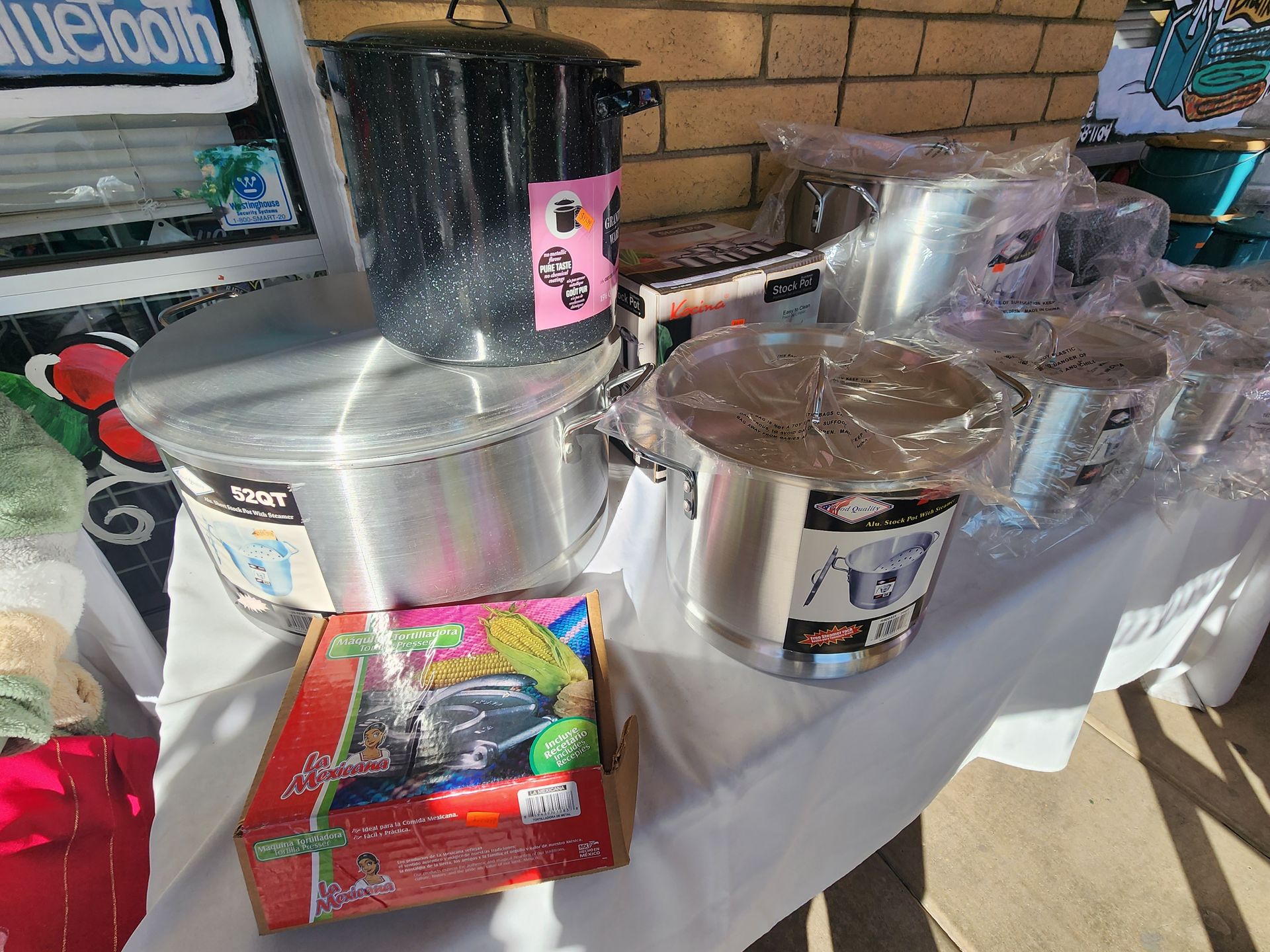 a table with a bunch of pots and pans on it