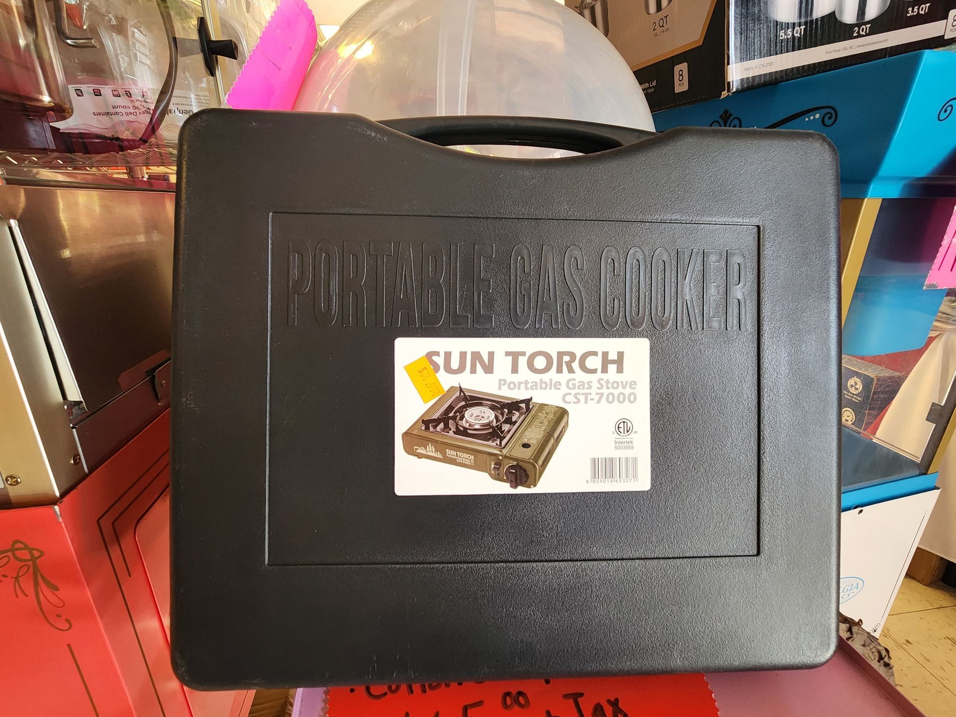 a sun torch portable stove in a black case