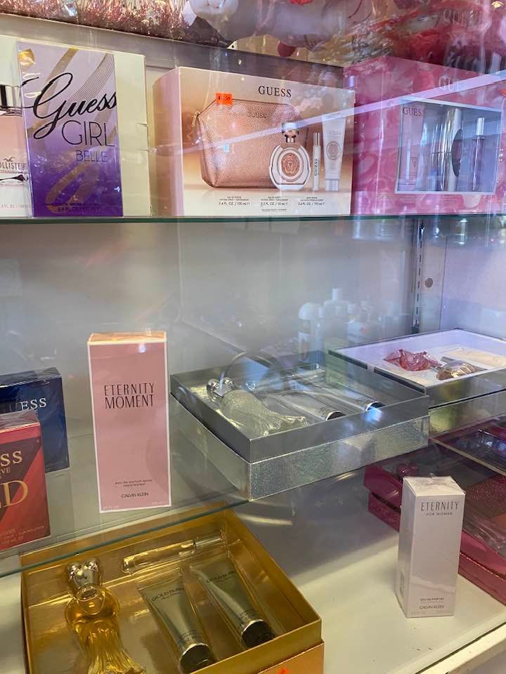 a display case filled with lots of perfumes and gifts .