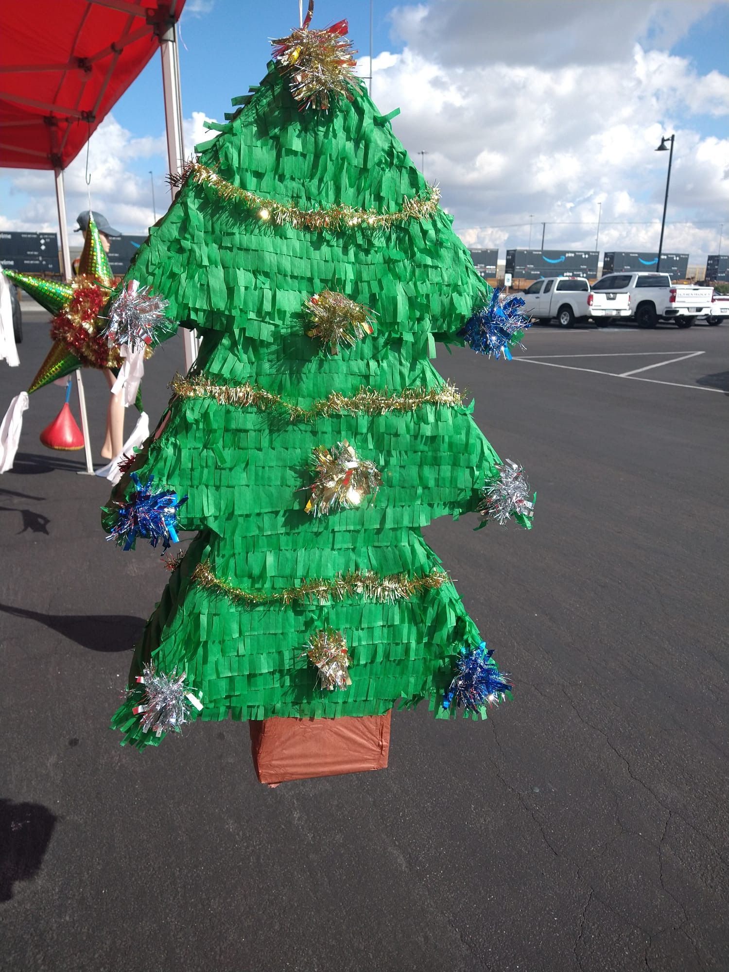 a green piñata in the shape of a christmas tree