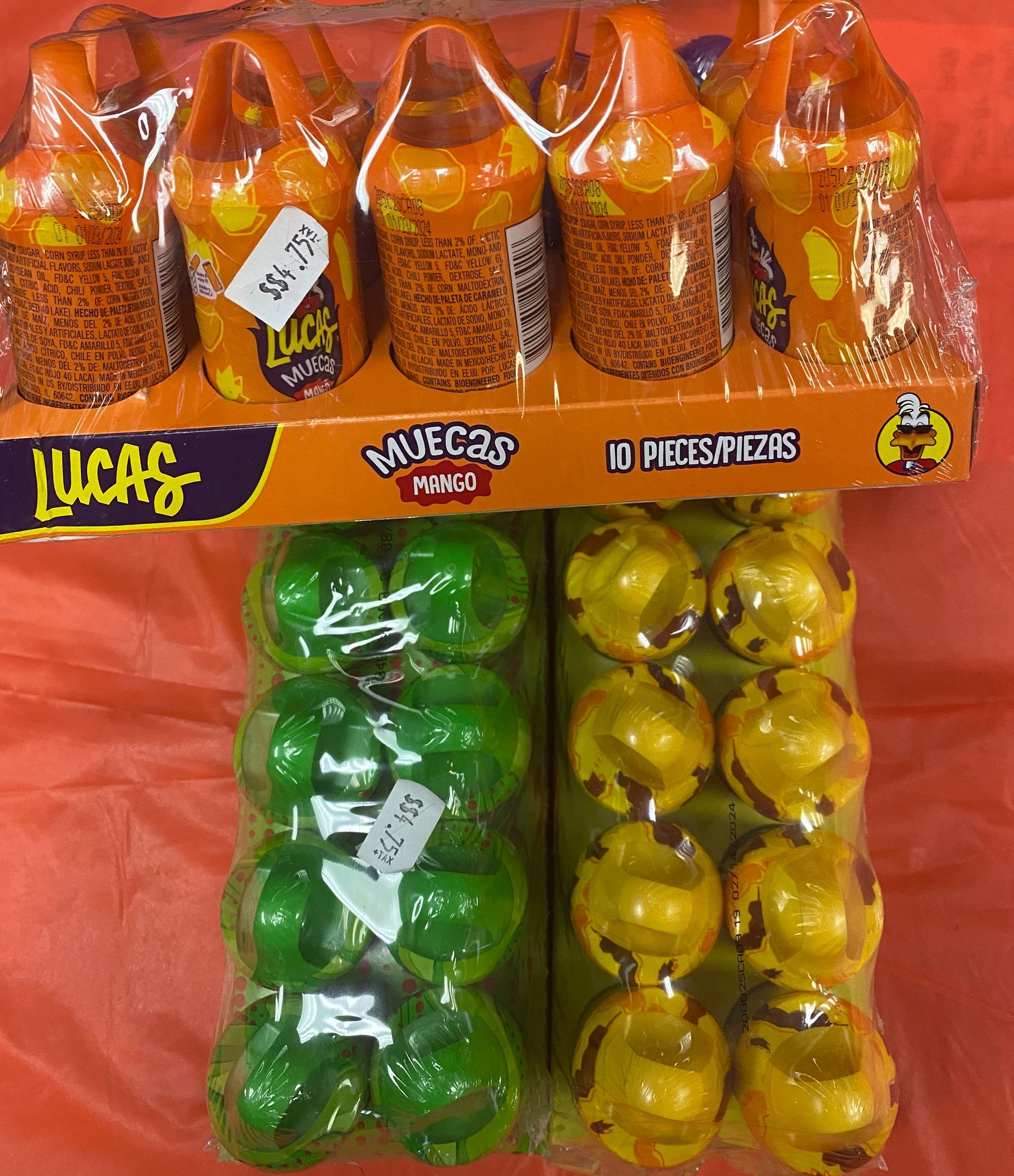 two bags of lucas candy are sitting next to each other on a table .