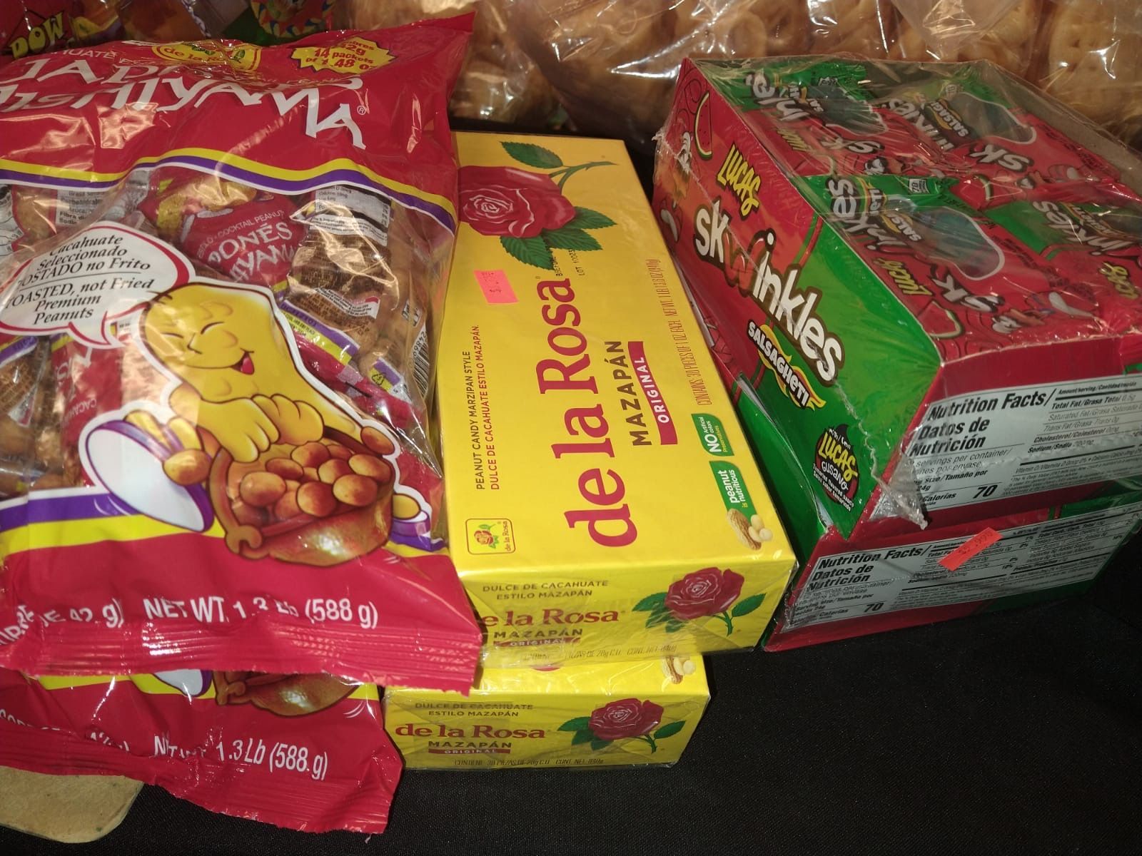 a bag of de la rosa candy sits next to a box of skittles