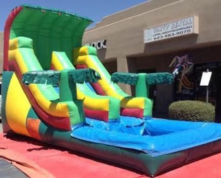 a large inflatable water slide is sitting in front of a building .