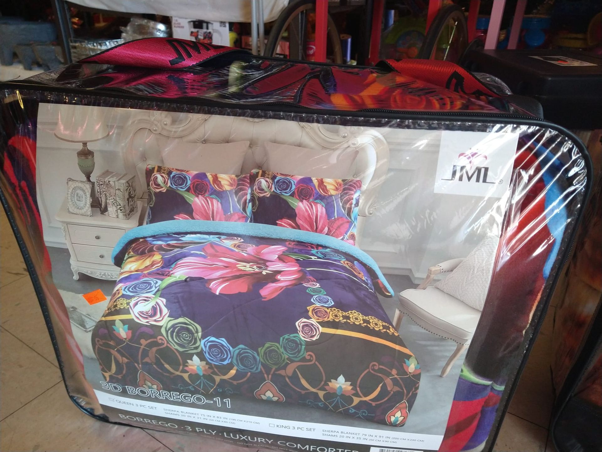 a bed with a purple comforter and pillows in a plastic bag