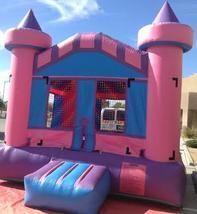a pink and purple bouncy castle is sitting on the ground 