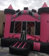 a pink and black bouncy castle is sitting in front of a building 