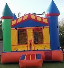 a colorful bouncy house is sitting on top of a lush green field 