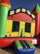 a colorful bouncy house is sitting on the side of a road 