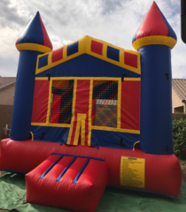 a red blue and yellow bouncy house is sitting on the ground