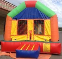 a colorful bouncy house is sitting in front of a building 