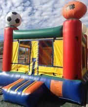 a bouncy house with a soccer ball and a basketball on top of it 