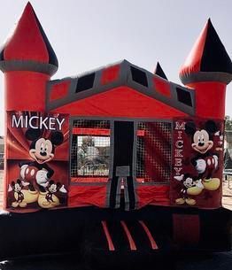 a red and black bouncy house with mickey mouse on it 