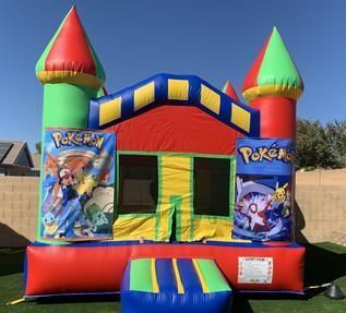 a pokemon bouncy house is sitting on top of a lush green field 