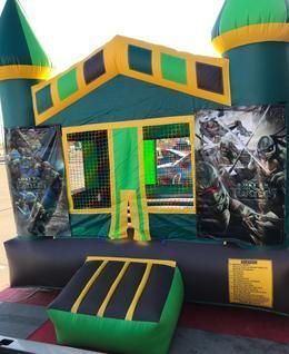 a green and yellow bouncy house with teenage mutant ninja turtles on it 