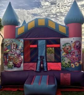 a pink and purple bouncy house with shopkins on it 