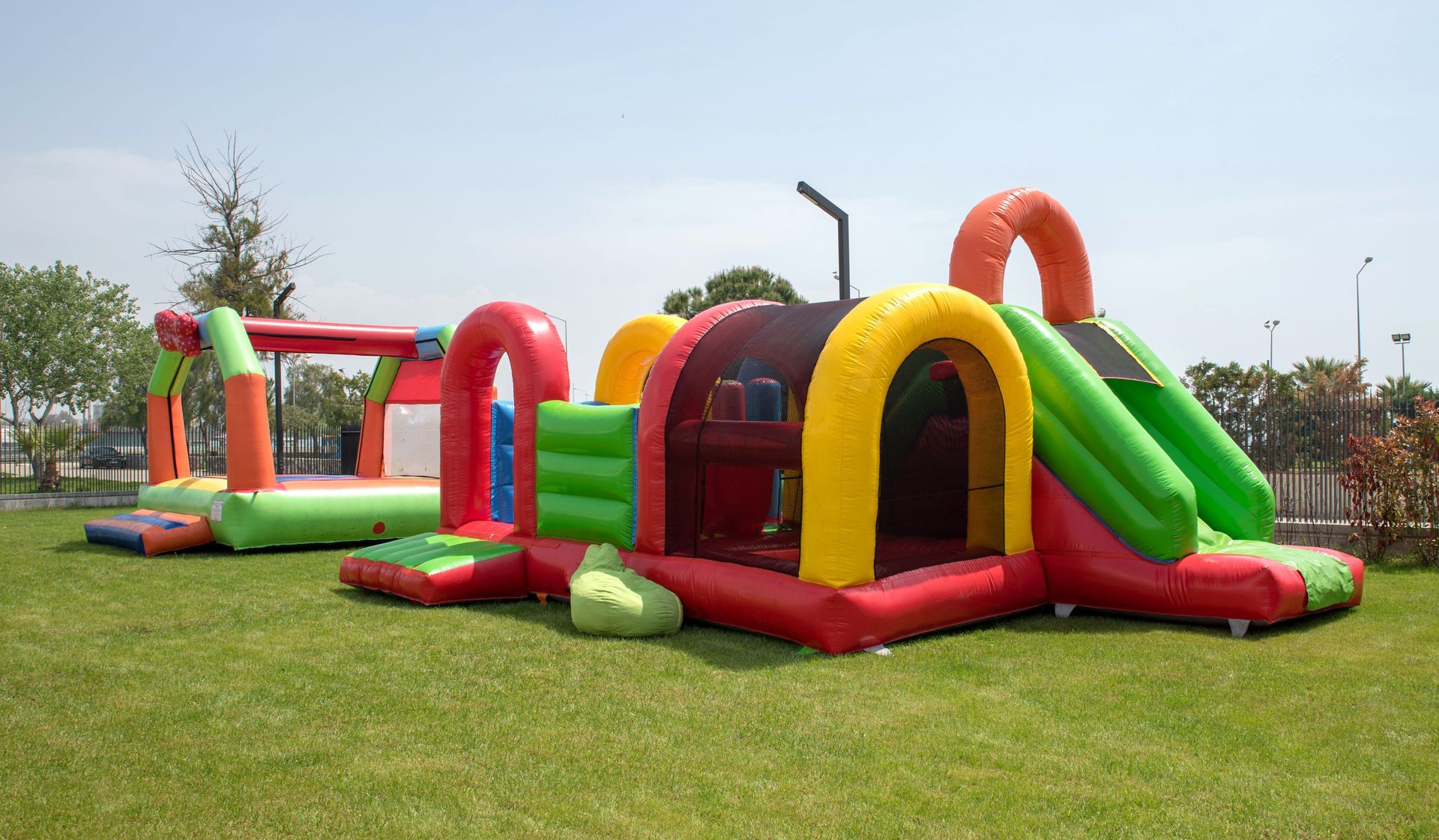 a bunch of inflatable toys are sitting on top of a lush green field