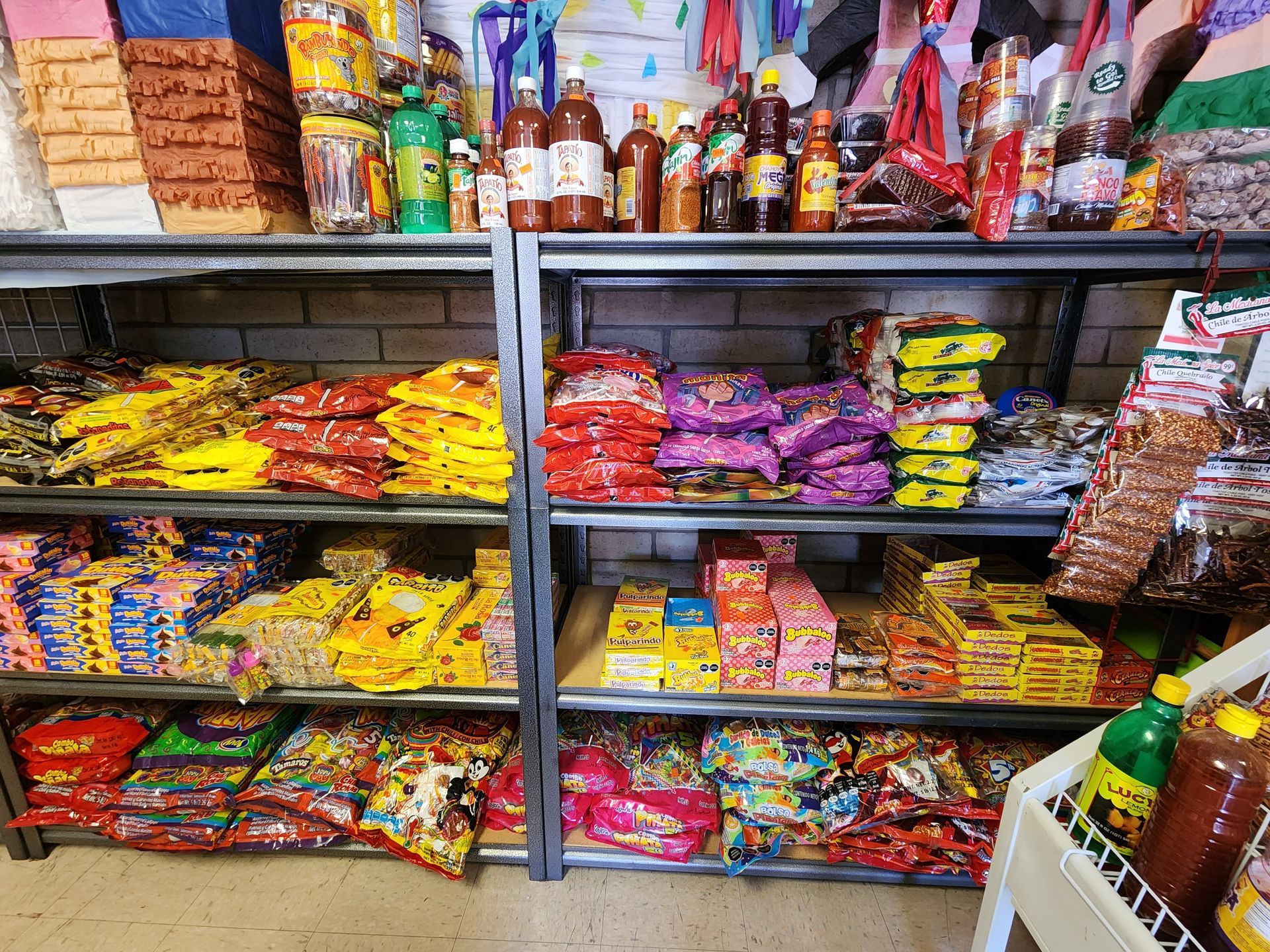 a store shelf filled with lots of different types of candy .