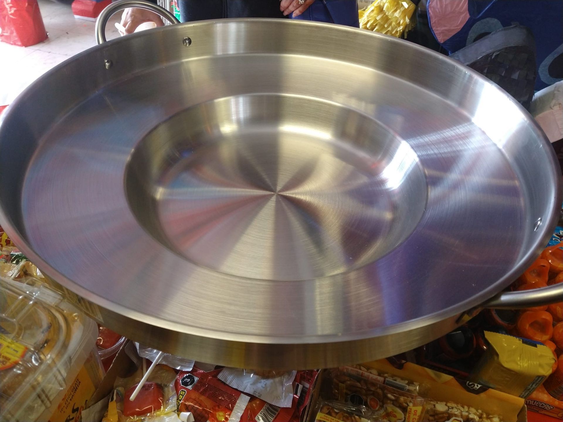 a large stainless steel pan is sitting on a table