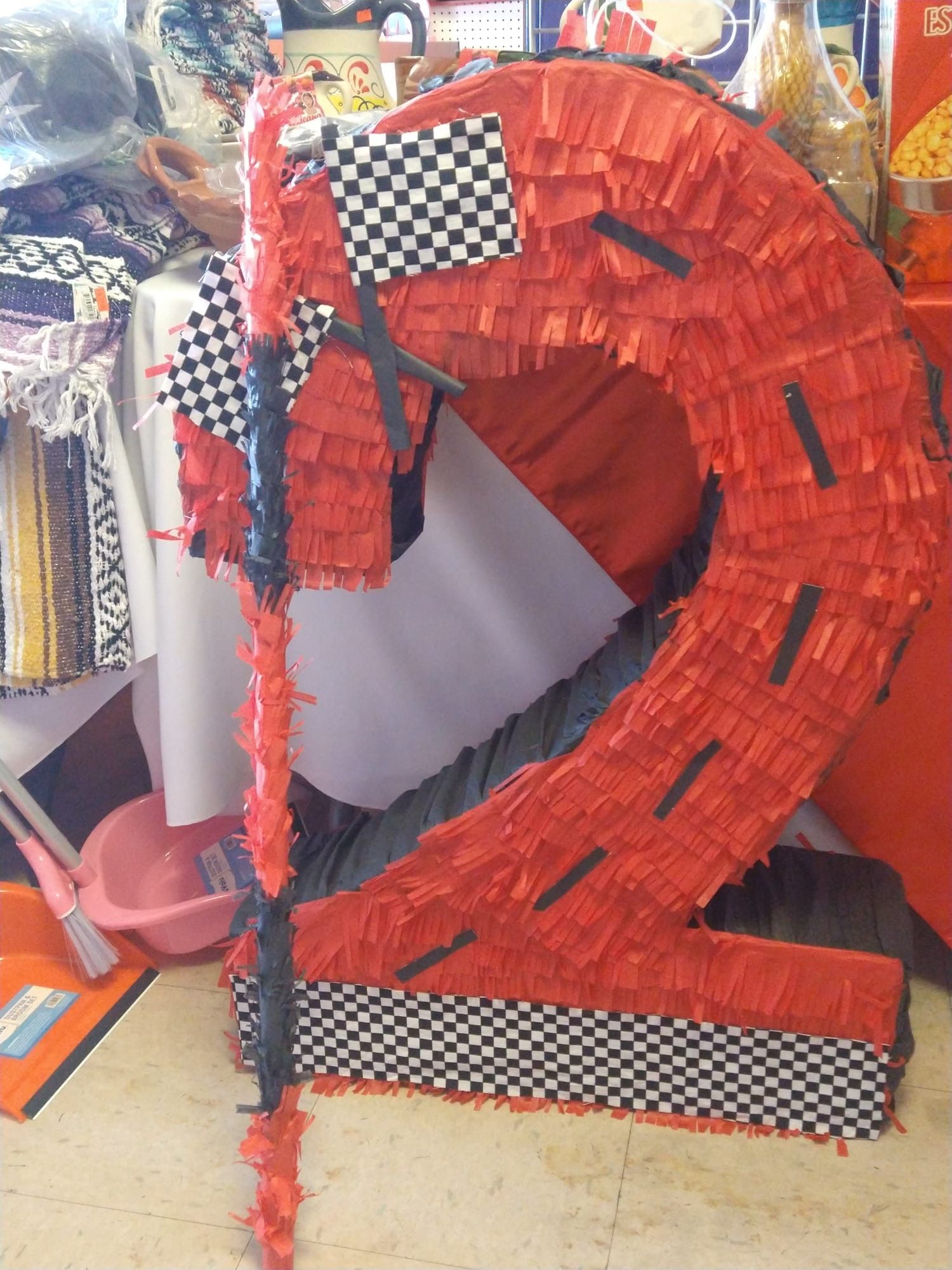 a red piñata in the shape of the number 2