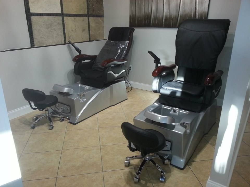 A room with two chairs and a stool in it