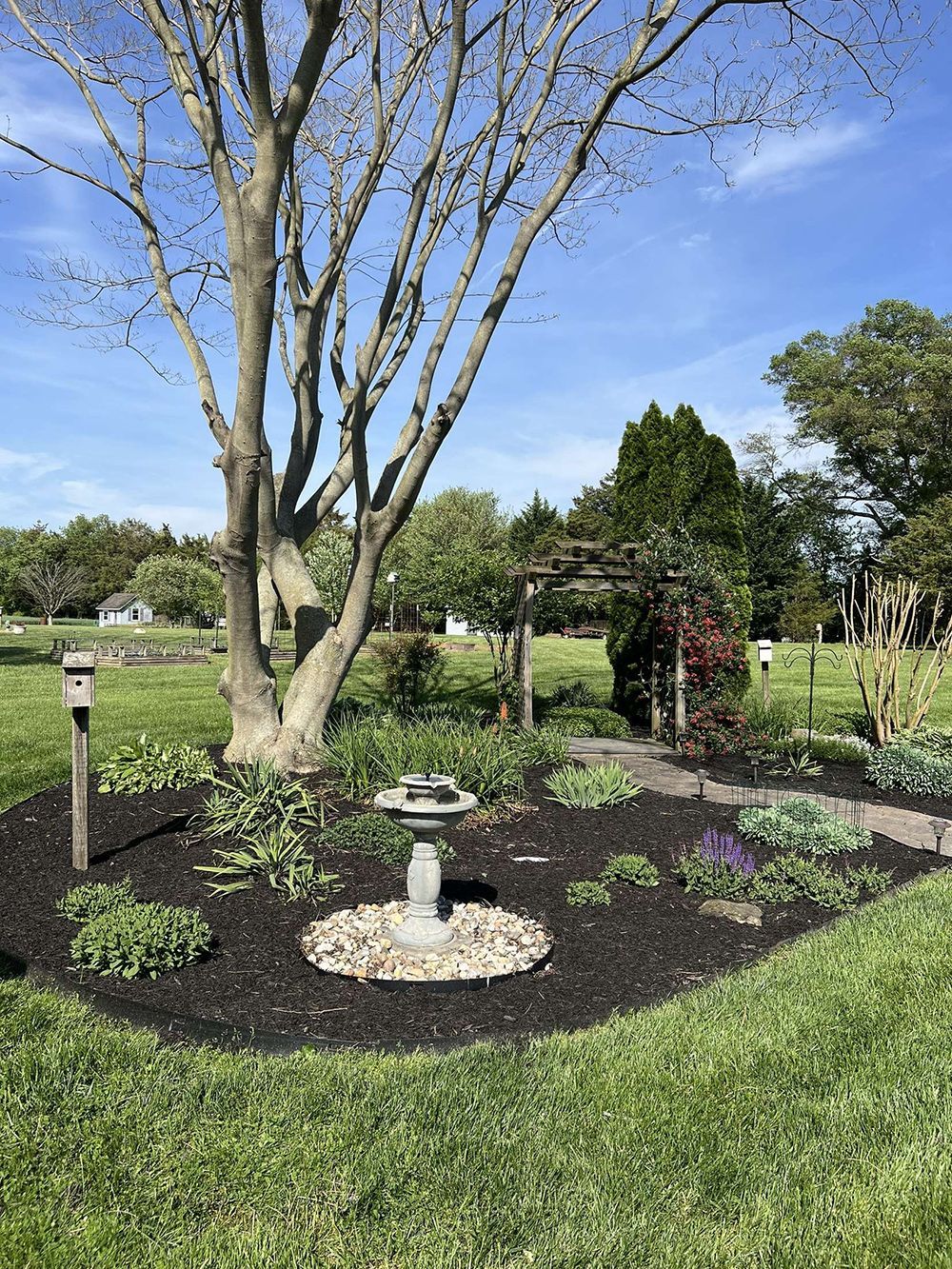 There is a fountain in the middle of the garden.
